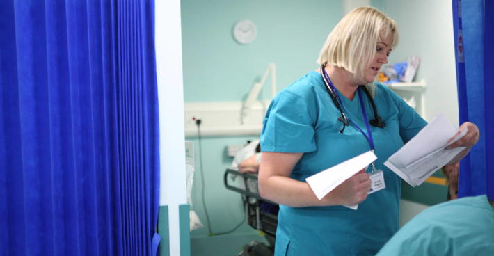 Female consultant with hospital paperwork